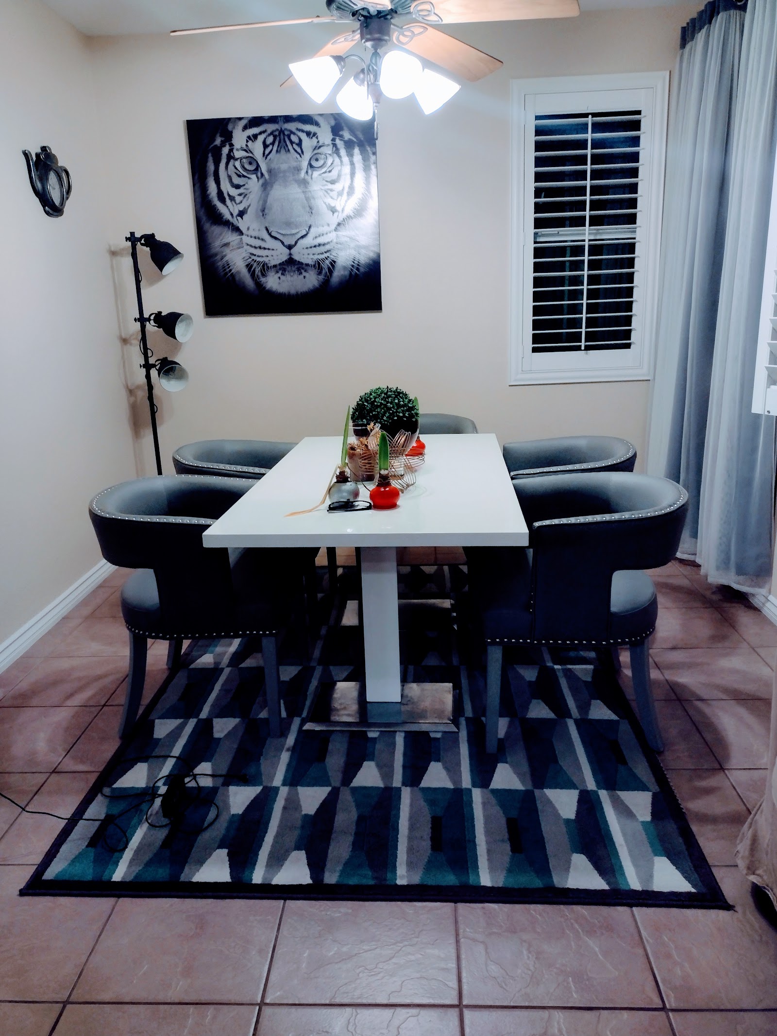 Tidy dining area with set table, rug and centerpiece