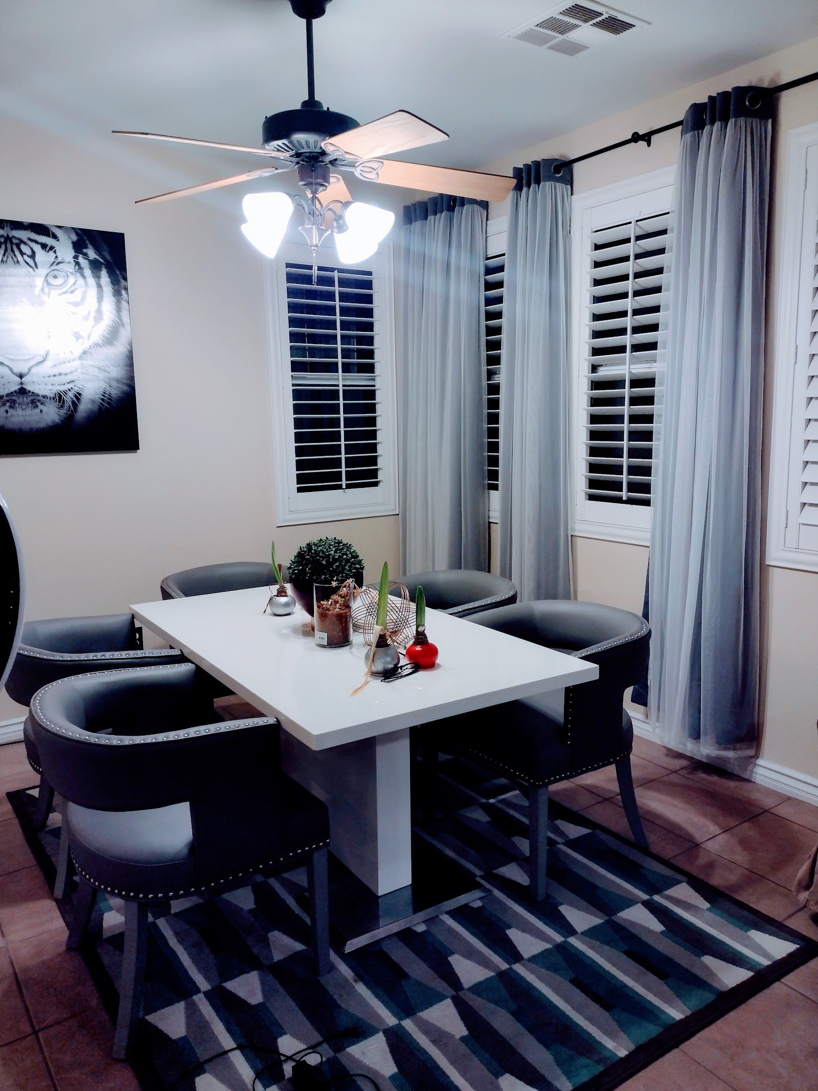 Dining room with staged table, chairs and curtains